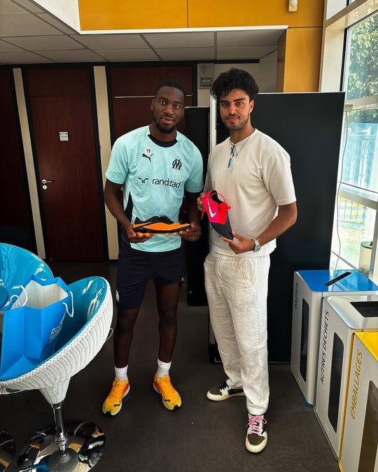 Footballer holding a pair from Boots Plug