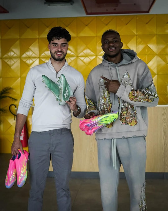 Footballer holding a pair from Boots Plug