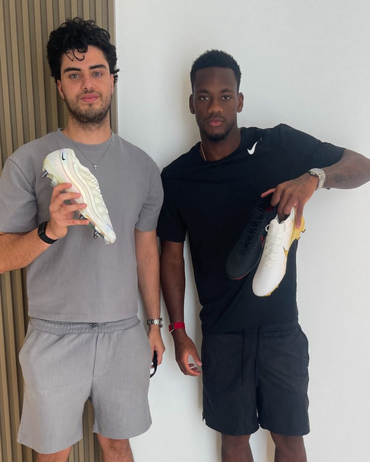 Footballer holding a pair from Boots Plug