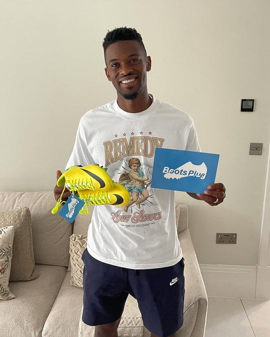 Footballer holding a pair from Boots Plug